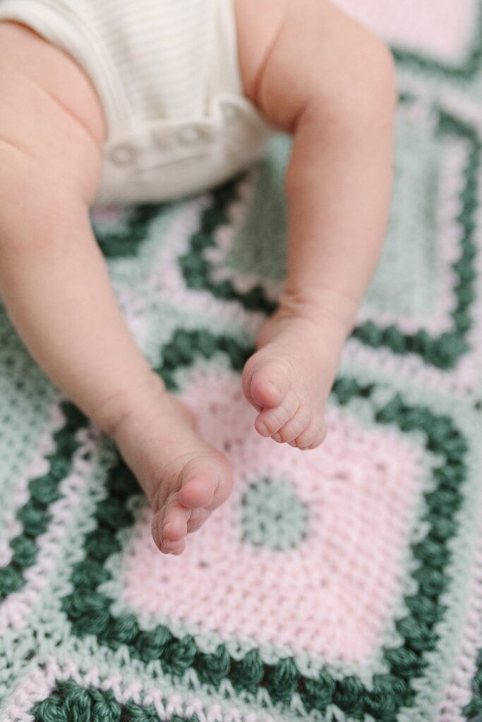 babies toes on baby blanket during in-home newborn photography session in Michigan
