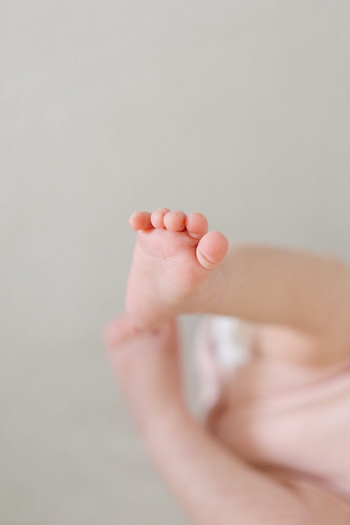 Newborn baby resting peacefully in the nursery during a lifestyle in-home newborn photography session.