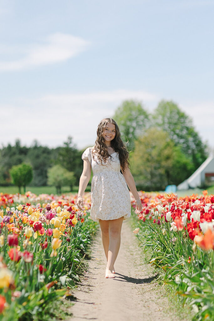 Spring senior session during Tulip Time with colorful tulip fields in Michigan