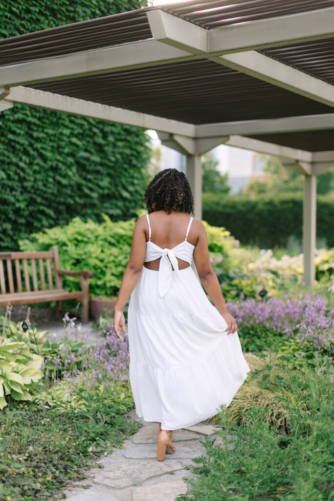 Feminine senior photos in East Lansing with soft natural light and floral backgrounds