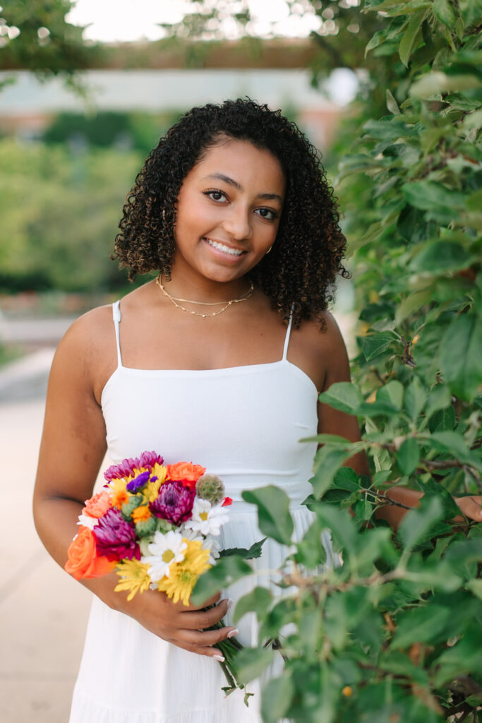 Soft glam senior portraits at MSU Gardens with flowers and dreamy summer light