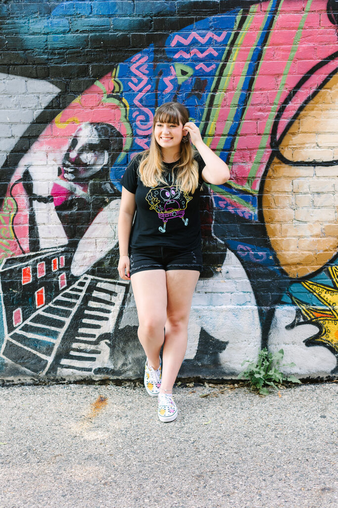Artistic senior portraits with colorful graffiti walls in Michigan