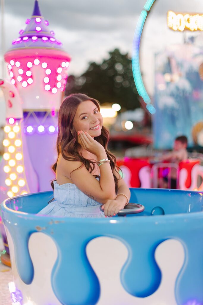 Senior Ambassadors laughing together on the teacup ride at the Ionia Free Fair.