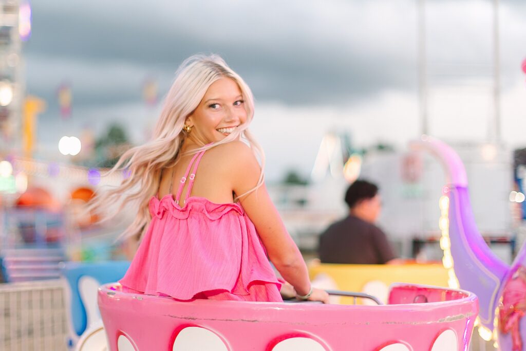 Senior Ambassadors laughing together on the teacup ride at the Ionia Free Fair.