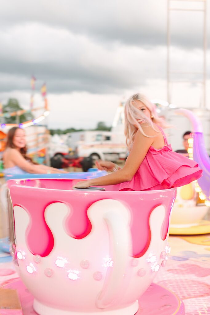Senior Ambassadors laughing together on the teacup ride at the Ionia Free Fair.