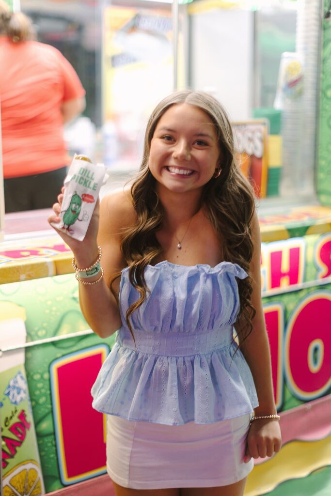 Mireya celebrating her long-awaited fair pickle during Senior Ambassador night at the Ionia Free Fair.