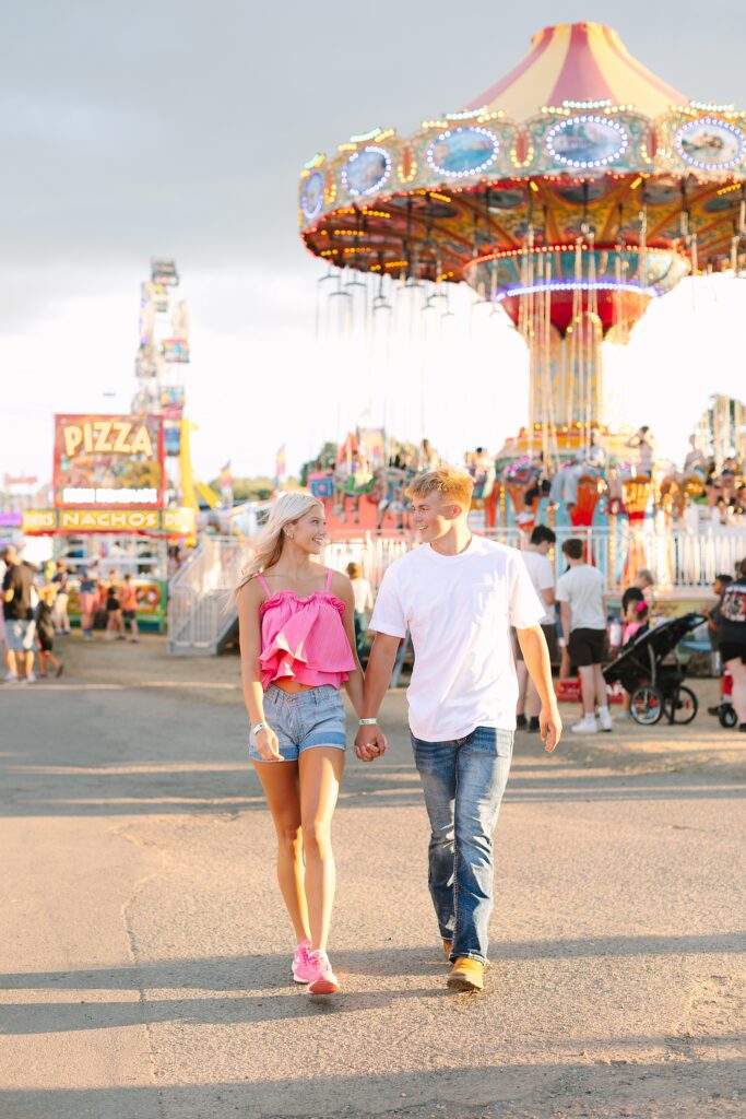 Charlie and Cameron walking through the midway together during their summer fair photo session.
