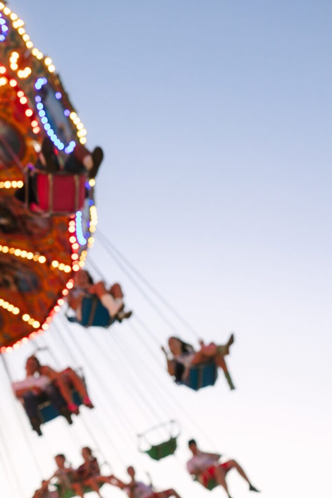 Senior Ambassadors enjoying the swinging chair ride during a summer evening at the Ionia Free Fair.
