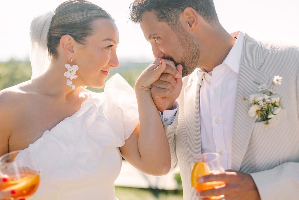 Newlyweds celebrate their marriage with a kiss during cocktail hour