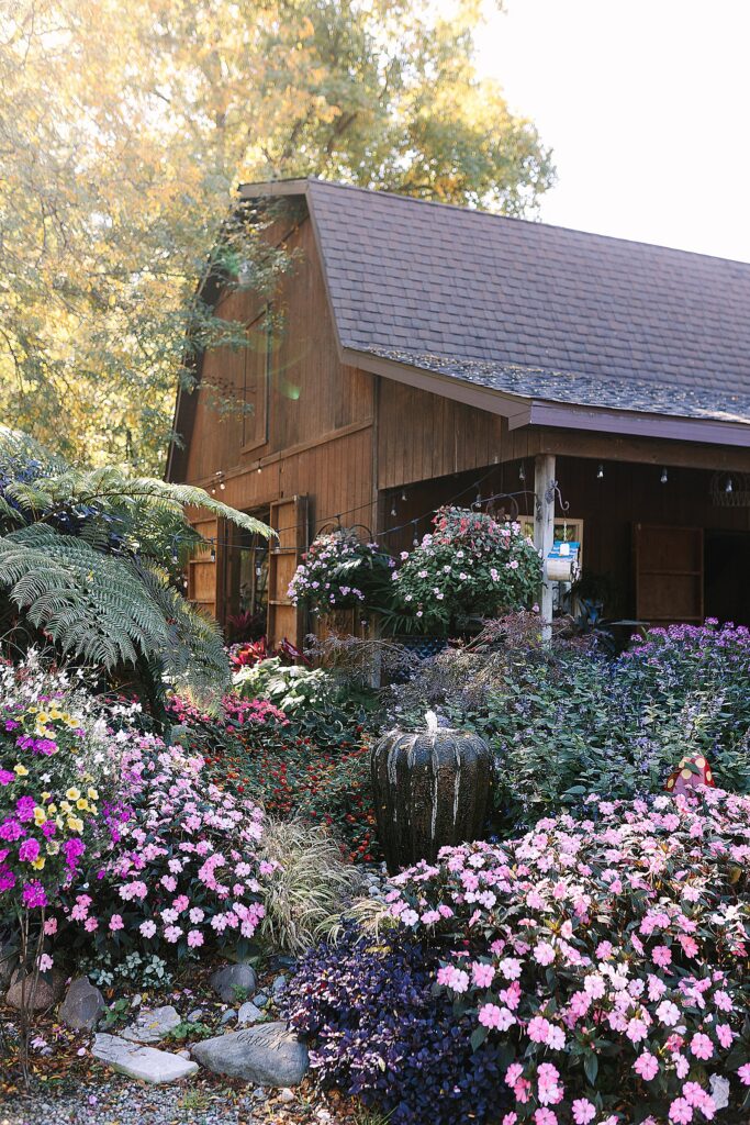 main building at everlastings in the wildwood wedding venue in owosso michigan surrounded by flowers