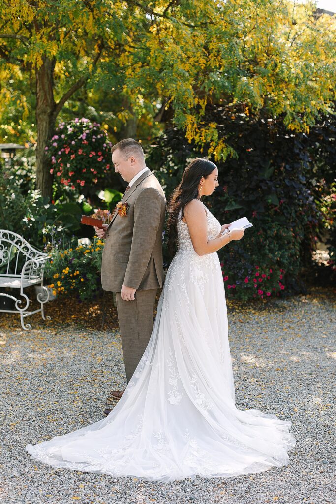 bride and groom opt for a first touch instead of a first look and are reading their vows while standing back to back