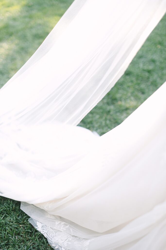 brides dress train and veil flowing during bride and groom portraits