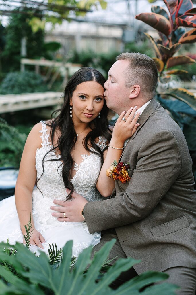 bride and groom portraits in the greenhouse at everlastings in the wildwood wedding venue